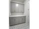 Neutral toned laundry room with ample counter and storage space, complemented by patterned tile flooring at 4155 Jean Laffite Rd, Hollywood, SC 29449