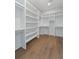 Spacious walk-in closet with custom shelving and wood flooring provides generous storage at 4155 Jean Laffite Rd, Hollywood, SC 29449