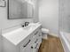 Modern bathroom features a white vanity, an undermount sink, and a large, framed mirror above at 4412 Abby Dr, North Charleston, SC 29418