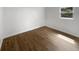 Sunlit bedroom features hardwood floors and a pair of windows with views of the trees outside at 4412 Abby Dr, North Charleston, SC 29418