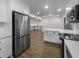 Bright kitchen features stainless steel appliances, white cabinets, and hardwood floors at 4412 Abby Dr, North Charleston, SC 29418