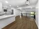 Open kitchen with white cabinets, quartz counters, stainless appliances, and wood floors at 4412 Abby Dr, North Charleston, SC 29418
