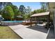 Inviting backyard with a swimming pool, a deck, and a covered outdoor seating area perfect for entertaining at 4429 Highway 162, Hollywood, SC 29449