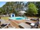 Backyard area with an above ground pool, deck with lounge chairs, a playhouse, and tree coverage at 4429 Highway 162, Hollywood, SC 29449