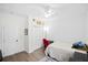 Bright bedroom featuring a ceiling fan, closet, light hardwood floors, and a red chair at 4429 Highway 162, Hollywood, SC 29449