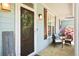 Inviting front porch with a welcome sign, seating, and beautiful plants creating a warm and inviting ambiance at 4429 Highway 162, Hollywood, SC 29449
