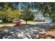 Charming single-story home with a long driveway surrounded by lush trees and ample parking space at 4429 Highway 162, Hollywood, SC 29449