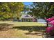 Charming single-story home with a well-manicured lawn framed by lush landscaping and mature trees at 4429 Highway 162, Hollywood, SC 29449