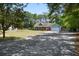 Charming single-story home with a long driveway surrounded by lush trees and ample parking space at 4429 Highway 162, Hollywood, SC 29449