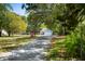 Charming single-story home with a long driveway surrounded by lush trees and ample parking space at 4429 Highway 162, Hollywood, SC 29449
