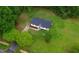 An aerial view of a charming home with well-maintained landscaping and a long driveway at 463 E Main Street, Harleyville, SC 29448