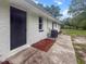 White brick house with a well-maintained backyard and concrete path at 463 E Main Street, Harleyville, SC 29448