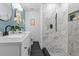 Elegant bathroom featuring a double vanity and a walk-in shower with beautiful marble tiling at 463 E Main Street, Harleyville, SC 29448
