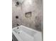 Bathroom featuring a tub-shower combination and modern hexagon tile wall design at 463 E Main Street, Harleyville, SC 29448