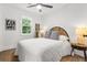 Cozy bedroom featuring a comfortable bed, stylish decor, and natural light from the window at 463 E Main Street, Harleyville, SC 29448