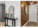 Entryway showcasing modern console table, mirror, and stylish accents next to a wood paneled wall at 463 E Main Street, Harleyville, SC 29448