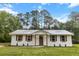 Charming renovated brick home featuring a metal roof, updated windows, and manicured front yard at 463 E Main Street, Harleyville, SC 29448