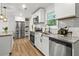 Bright and airy kitchen with stainless steel appliances, granite countertops, and modern white cabinets at 463 E Main Street, Harleyville, SC 29448