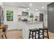 Modern kitchen with white cabinets, stainless steel appliances, granite countertops, and a center island with seating at 463 E Main Street, Harleyville, SC 29448