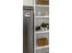 Close-up of kitchen shelving next to a stainless steel refrigerator, offering convenient storage at 463 E Main Street, Harleyville, SC 29448