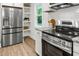 Well-appointed kitchen featuring stainless steel appliances, white cabinets, and open shelving for added storage at 463 E Main Street, Harleyville, SC 29448
