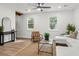 Bright living room featuring neutral decor, natural light from large windows, and wood-look flooring at 463 E Main Street, Harleyville, SC 29448