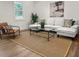 Cozy living room with a comfortable white sofa, stylish decor, and a jute rug, perfect for relaxation at 463 E Main Street, Harleyville, SC 29448