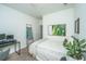 Minimalist bedroom with a modern bed frame, a desk, and abstract artwork on the wall at 5009 W Liberty Park Cir, North Charleston, SC 29405