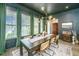 Elegant dining room with dark walls, statement lighting, and a large wooden table at 5009 W Liberty Park Cir, North Charleston, SC 29405