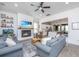 Inviting living room features a cozy fireplace, plush sofas, and an open layout to the kitchen at 5009 W Liberty Park Cir, North Charleston, SC 29405