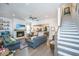 Open-concept living room featuring fireplace, hardwood floors, and abundant natural light, perfect for entertaining and relaxation at 5009 W Liberty Park Cir, North Charleston, SC 29405