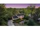 Aerial view of a charming two-story traditional home featuring a lush landscaped front yard and surrounded by mature trees at 506 Fairington Dr, Summerville, SC 29485