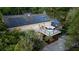 Aerial view of brick home with sunroom, balcony, and solar panels at 506 Fairington Dr, Summerville, SC 29485