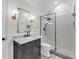 Stylish bathroom with modern fixtures, patterned wallpaper, and glass enclosed shower at 506 Fairington Dr, Summerville, SC 29485