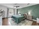 Stylish bedroom with a geometric accent wall, ceiling fan, and warm wood floors at 506 Fairington Dr, Summerville, SC 29485