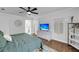 Bright bedroom featuring wood floors, a TV, and decoratively painted dresser at 506 Fairington Dr, Summerville, SC 29485
