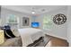Bright bedroom featuring wood floors, a ceiling fan, television, and multiple windows at 506 Fairington Dr, Summerville, SC 29485