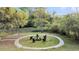 Landscaped backyard with a circular firepit and seating area at 506 Fairington Dr, Summerville, SC 29485