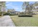 Charming two-story traditional home with a landscaped front yard, manicured hedges, mature trees, and a paved driveway at 506 Fairington Dr, Summerville, SC 29485