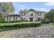 Charming two-story traditional home with a landscaped front yard, manicured hedges, mature trees, and a stone bench at 506 Fairington Dr, Summerville, SC 29485