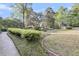 Well-manicured front yard featuring lush greenery and a charming brick-lined garden at 506 Fairington Dr, Summerville, SC 29485