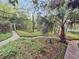 Well-maintained garden with walking path and mature trees, creating a serene and natural ambiance at 506 Fairington Dr, Summerville, SC 29485