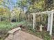 Secluded garden bench with a stone pathway and beautiful pergola at 506 Fairington Dr, Summerville, SC 29485