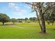 Expansive green space featuring a pond and walking paths shaded by mature trees at 506 Fairington Dr, Summerville, SC 29485