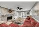 Inviting living room with brick fireplace, hardwood floors and a comfortable sectional sofa at 506 Fairington Dr, Summerville, SC 29485