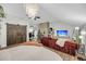 Open living room featuring a large sofa, modern lighting, brick accent wall, and neutral paint at 506 Fairington Dr, Summerville, SC 29485