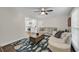 Bright living room showcasing an area rug, ceiling fan and connection to kitchen through a wide doorway at 506 Fairington Dr, Summerville, SC 29485