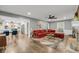 Comfortable living room with a brick fireplace, plush red sofa and dining room view at 506 Fairington Dr, Summerville, SC 29485