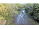 Natural muddy stream with banks covered in green vegetation and trees, evoking a sense of tranquility at 506 Fairington Dr, Summerville, SC 29485