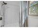 Shower with white subway tile surround, shower head, faucet, and curtain near a bright window at 506 Fairington Dr, Summerville, SC 29485